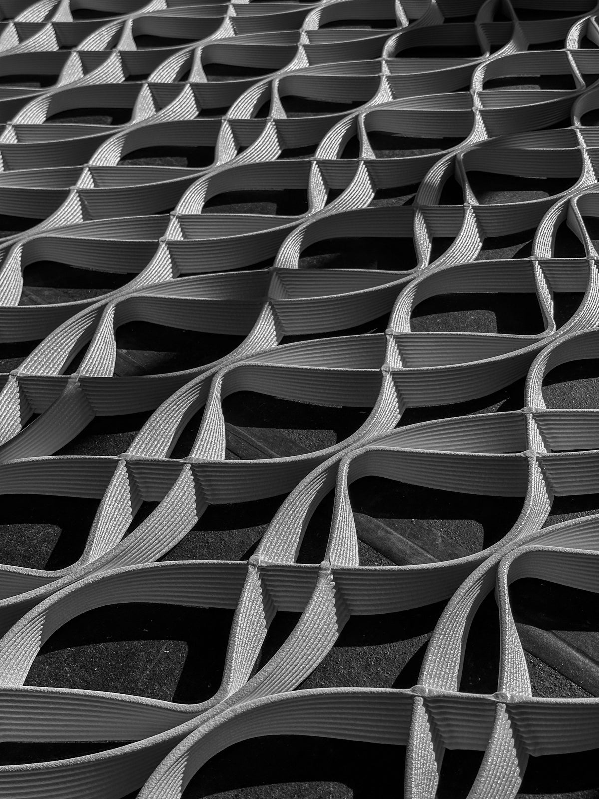 Black-and-white close-up of layered printed mesh loops for lululemon’s Prudential Center architectural installation in Boston.