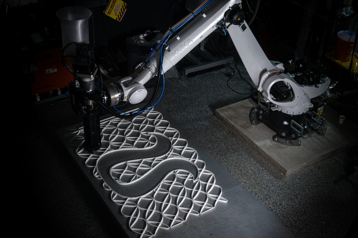 Robotic production of interlocking mesh panels with an integrated lululemon logo shape.
