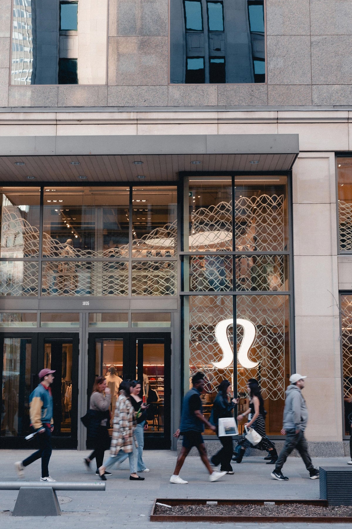 Street view of lululemon’s Montréal storefront with architectural mesh across the windows.